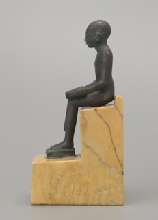 Figurine of Imhotep, Imhotep ca. 2667–2648 BC; mythology. Seated male figurine holding an unrolled