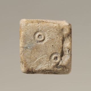 Six-sided dice with pips 1–6 shown as hollow circles and dots; material unspecified; maker and