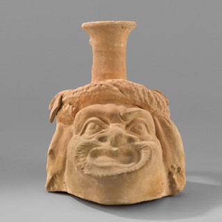 Vessel with a belly in the shape of a comic mask; unknown Greek workshop; plastic vessel;
