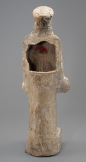 Female terracotta figurine of a standing woman positioned frontally on a quadrangular base. The
