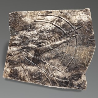 Fragment of an orthostat with relief decoration, unknown Neo-Assyrian workshop. Fragment of a stone
