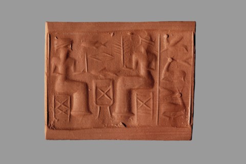 Cylinder seal with a banquet scene, unknown Assyrian workshop. The cylinder's surface is engraved