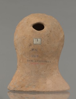 Votive female head, Female head wearing a wreath, from under which lush locks of hair curl down the