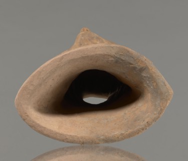 Votive female head, Female head wearing a wreath, from under which lush locks of hair curl down the