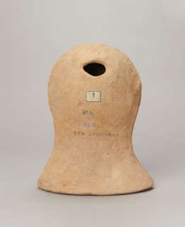 Votive female head, Female head wearing a wreath, from under which lush locks of hair curl down the