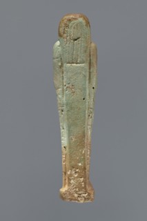 Ushabti, Mummy-shaped figurine, standing on a base, supported by a pillar/pilaster at the back.