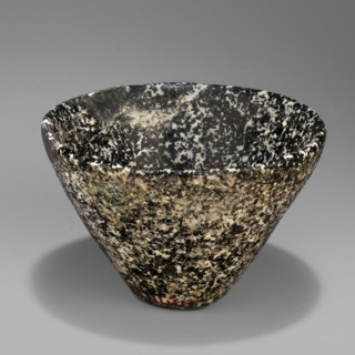 Bowl with high walls widening toward the top; rim rounded and slightly beveled inward; small flat