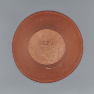 Deep, cup-shaped clay bowl with a slightly convex bottom and sides arching upwards, straight