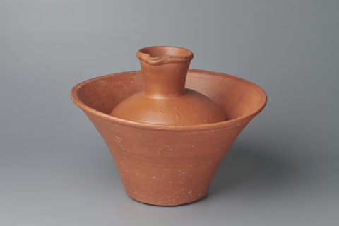 Jug. Medium-sized biconical clay jug with wide, sloping shoulders and a wide neck that is almost