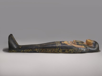 Lid of an anthropoid sarcophagus of a woman with clearly modeled legs. The head is sculpturally
