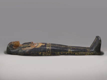 Lid of an anthropoid sarcophagus of a woman with clearly modeled legs. The head is sculpturally