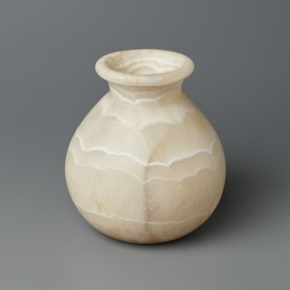 Vessel, unknown creator; globular stone vessel with a short, wide neck and a large upturned spout,