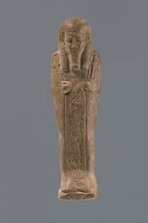 Ushabti, Mummy-shaped figurine, standing on a base with a pilaster at the back. Arms crossed on the
