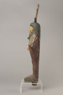 Figurine of Osiris in the form of a human mummy wearing a hemhem crown with ram's horns. On the