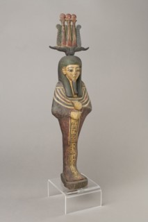 Osiris, Osiris mythology. Figurine in the form of a human mummy wearing a hemhem crown with ram's