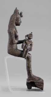 Figurine of the goddess Isis nursing Horus. The figurine depicts a seated Isis with the child Horus