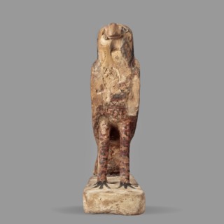 Figurine of the falcon Sokaris Horus, a painted Egyptian sculpture: a falcon stands on a thick