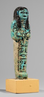 Shabti of the Lady of Renu, Mummy-shaped figurine made of blue faience with dark details. Arms
