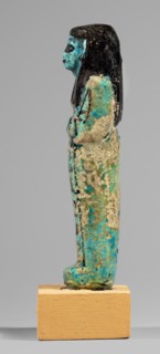 Shabti of the Lady of Renu, Mummy-shaped figurine made of blue faience with dark painted details;