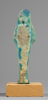 Ushabti, back pillars, hoes, funerary figurines, wigs, grave goods; Mummy-shaped figurine, standing