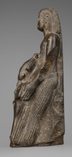 Figurine of a priest with a statuette of the god Osiris, The priest is shown standing, holding in