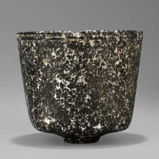 Stone vessel. Vessel with a quadrangular bottom and an almost cylindrical body profiled below the