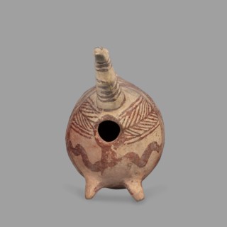 Vessel in the shape of a fantastic animal. The neck is long and thin, ending in a triangular,