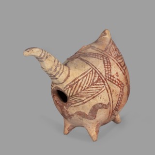 Vessel in the shape of a fantastic animal. The neck is long and thin, ending in a triangular,