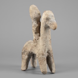 Figurine of a rider on a horse. The entire piece is schematic, the overall shape is highlighted,