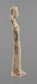 Terracotta figurine of a woman, unknown Boeotian workshop. Female mold-pressed figurine standing in