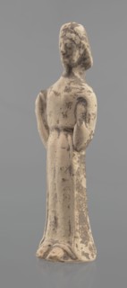 Terracotta figurine of a woman, unknown Boeotian workshop. Female mold-pressed terracotta figurine.