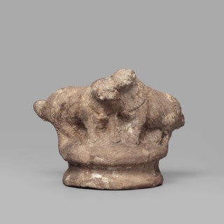 Two dogs, Two dogs shown schematically on a round, profiled base. The dogs are shown standing, with