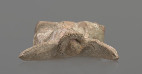 Terracotta figurine of Eros with a goose. Figurine of a standing Eros: the figure, positioned