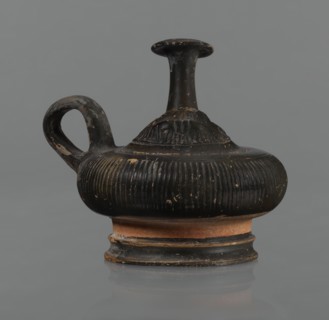 Black-finned guttus, guttus, Greek pottery, black-finned pottery. Guttus with a high foot composed