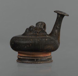 Black-finned guttus, guttus, Greek pottery, black-finned pottery. Guttus with a high foot composed