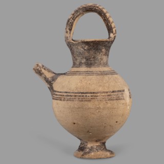 Jug on a ring-shaped foot, from which a low, wide stem extends, transitioning into a belly. The