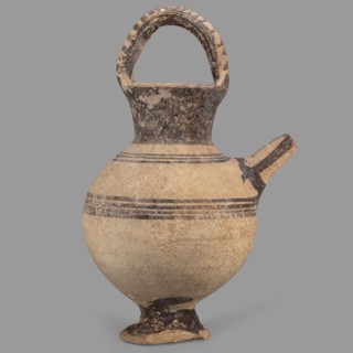 Jug on a ring-shaped foot, from which a low, wide stem extends, transitioning into a belly. The