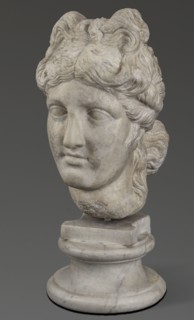 Head of the goddess Aphrodite, Greek sculpture, female portrait; hair tied in a bow at the front,