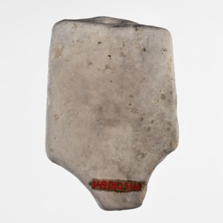 Fragment of a figurine of a woman on a bed. Flat figurine of a concubine resting on a plate
