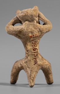 Satyr figurine, clay; depicts a satyr with a face stylized as a mask with protruding ears and two