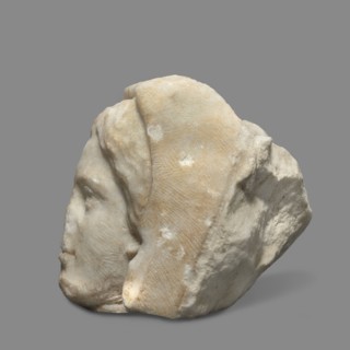 Head of a woman wearing a veil. The face is oval with regular features: rounded chin, small compact