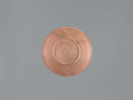Plate, unknown Aswan workshop; flat plate on a low ring-shaped foot. Rim poorly defined, rounded at