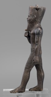 Figurine of the god Amun; maker, Amun mythology; Egyptian deity male figurine; once held a khepesh;