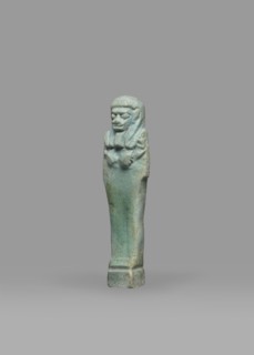 Ushabti, Mummy-shaped funerary figurine shabti, standing on a base, back supported by a