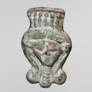 Amulet — head of the goddess Hathor;, Face of the goddess Hathor in a Hathor wig with a wreath of