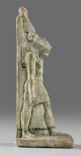 Amulet - god Mahes; figurine of a striding lion-headed male deity wearing an atef crown, dressed in