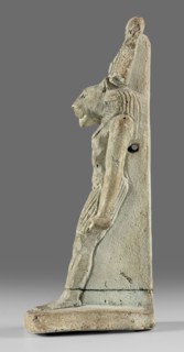 Amulet - god Mahes. Figurine of a striding lion-headed male deity wearing an atef crown, dressed in