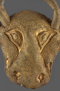 Protoma; bull's head relief mask made in gold using repoussé, granulation, and filigree. Central