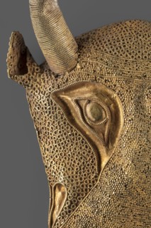 Protoma; bull's head relief mask made in gold using repoussé, granulation, and filigree; eyes,