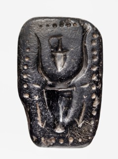 Stamp seal with a depiction of a bull's head. Stamp seal with a full, arched handle with a